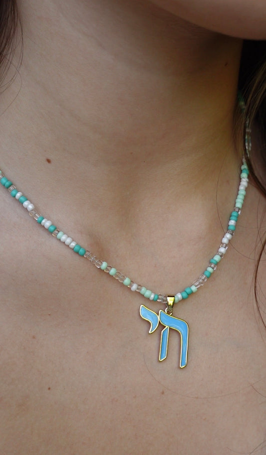 The Hädera Necklace: aqua, mint and white seed beads with a baby-blue enamel chai pendant